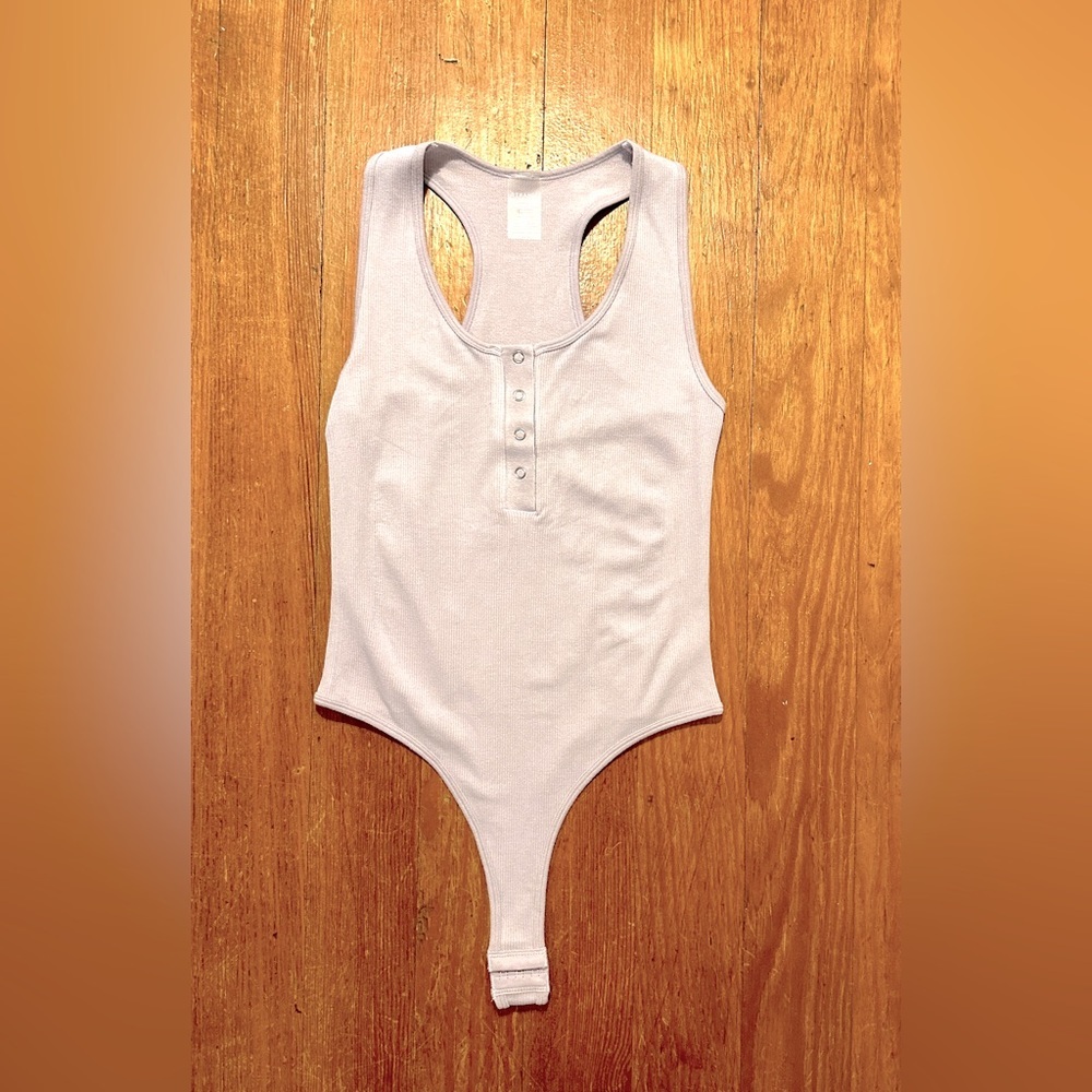 Women’s bodysuit in light lavender, one size fits most, never worn, NWOT